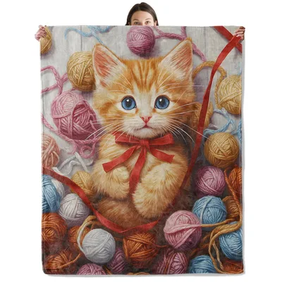 Orange Kitten with Yarn Blanket: Sweet Tabby Amidst Colorful Balls