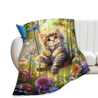 Kitten on Swing Among Blanket: A fluffy cat sits