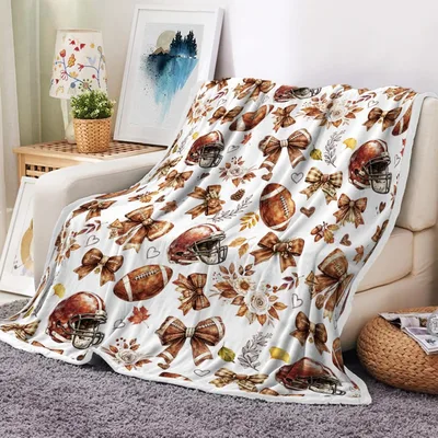 Fall Football Bows Blanket featuring brown ribbons helmets