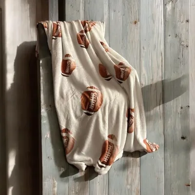 Cream Gridiron Ball Pattern Blanket: Classic Football Print for Fans