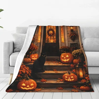 Black Cat on Pumpkin Porch Blanket featuring a black cat sitting