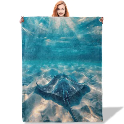 Stingray Ocean Blanket: A Blue Stingray Gliding Over Sandy Seabed