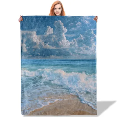 Ocean Waves Crashing Blanket: Coastal Scene with Clouds and Sand
