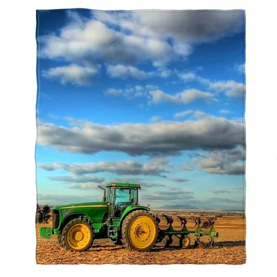Farm Tractor in Field Blanket: Green Machine Under Clouds